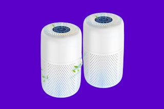 Two small-room HEPA air purifiers stand against a purple background.