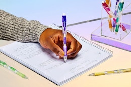 a woman writing with a paper mate mechanical pencil
