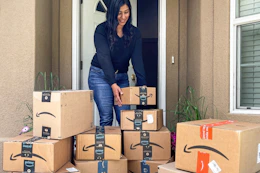 a woman grabbing an amazon box on a front porch