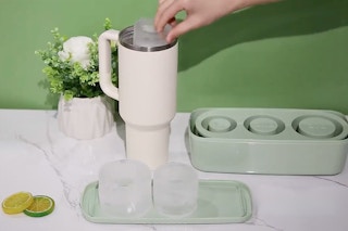 someone putting ice in their tumbler