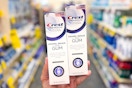 hand holding two crest gum toothpastes