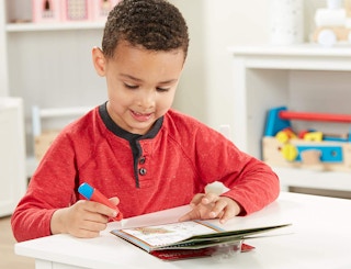 a kid drawing on an activity pad