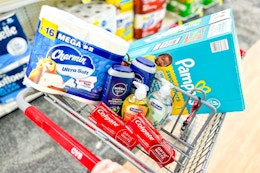 charmin toilet paper, pampers diapers, nivea body wash, softsoap hand soap, and colgate toothpaste in a cart