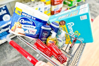 charmin toilet paper, pampers diapers, nivea body wash, softsoap hand soap, and colgate toothpaste in a cart