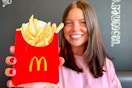 a person holding up a mcdonalds french fry 