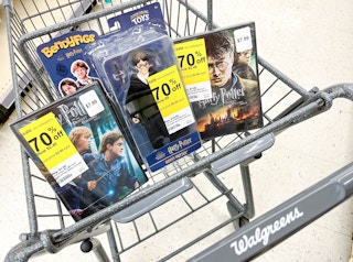 shopping cart with two Harry Potter DVDs and a Harry Potter action figure inside