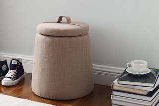 storage ottoman by a stack of books and sneakers