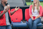 a woman and man sitting on folding chairs