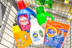 Tide, Arm & Hammer, All, Gain, and Persil laundry detergents in a shopping cart