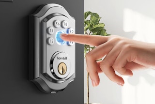 a person use their fingerprint on a door lock