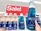 hand holding a brita water bottle in front of a target shelf
