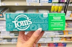 hand holding tom's of main toothpaste in cvs