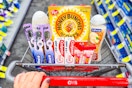 hand pushing cvs shopping cart filled with products