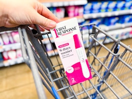 hand holding a first response box on Walmart cart