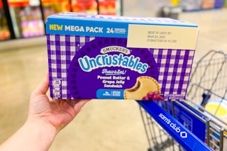 box of smuckers uncrustables sitting on shopping cart