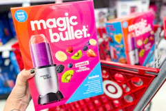 hand holding a magic bullet blender set in front of target cart