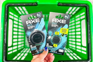 hand holding axe car air fresheners above green shopping basket