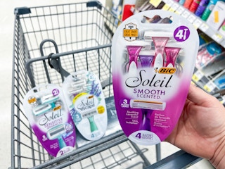 hand holding bic razor in front of shoppings cart