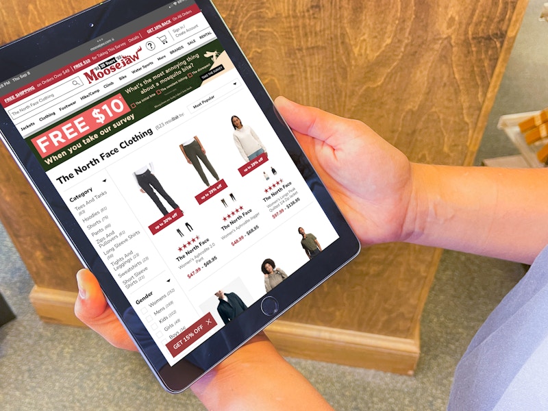 a person on a ipad with moose jaw website on