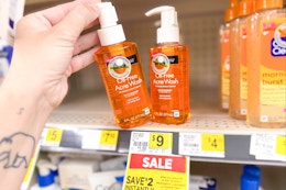 hand grabbing a bottle of neutrogena acne wash