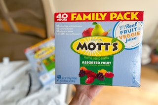 Person holding Mott's Fruit Snacks 40-Packs with Prime bag in background