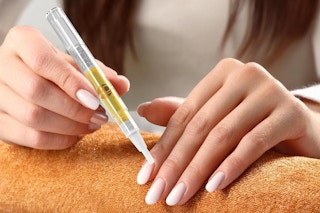 person applying callus liquid protector