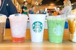 various hot and cold starbucks drinks on table