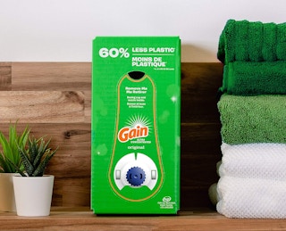A box of Gain laundry detergent on a shelf.