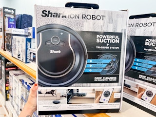 someone holding a shark robot
