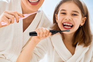 woman holding toothbrush