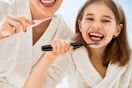two people holding an electric toothbrush