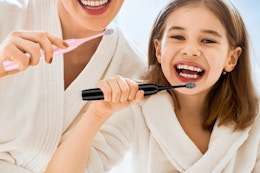 two people holding an electric toothbrush