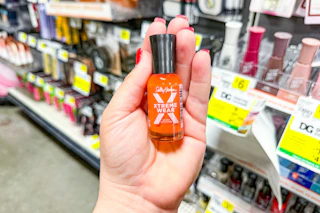 hand holding a bottle of sally hansen nail polish at dollar general