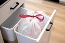 Full trash bag inside trash bin