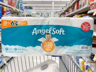 An Angel Soft 16 roll pack of toilet paper sitting atop a store cart.