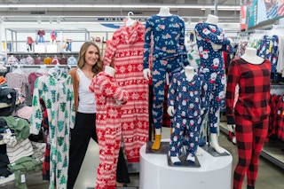 A woman posing with some onesie family pajamas in Old Navy