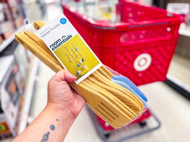 hand holding room essentials bamboo kitchen utensil set in front of target cart
