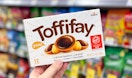 hand holding a Toffifay candy box