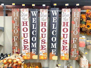 wooden hanging signs for fall on display at WAlmart