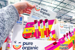 hand holding a box of pure organic fruit bars