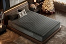 Lifestyle image of the black Ifluous Memory Foam/Coil Blend Mattress in bedroom with a Christmas tree