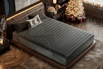Lifestyle image of the black Ifluous Memory Foam/Coil Blend Mattress in bedroom with a Christmas tree