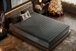 Lifestyle image of the black Ifluous Memory Foam/Coil Blend Mattress in bedroom with a Christmas tree