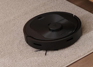 a robot vacuum on a rug in a room