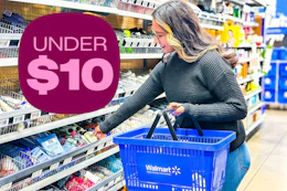 model grabbing lotion out the travel essentials are holding a Walmart basket