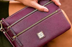 Close up lifestyle shot of a Dooney & Bourke Wristlet