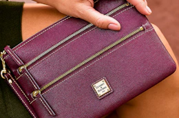 Close up lifestyle shot of a Dooney & Bourke Wristlet