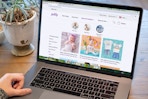 An open laptop sitting on a table, displaying Zulily.com's page for their Baby department.