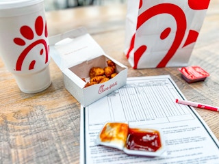 chick fil a nuggets next to a child's report card