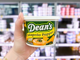 hand holding a tub of deans dip